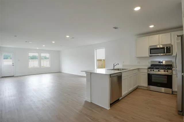 a kitchen with granite countertop a stove and a sink
