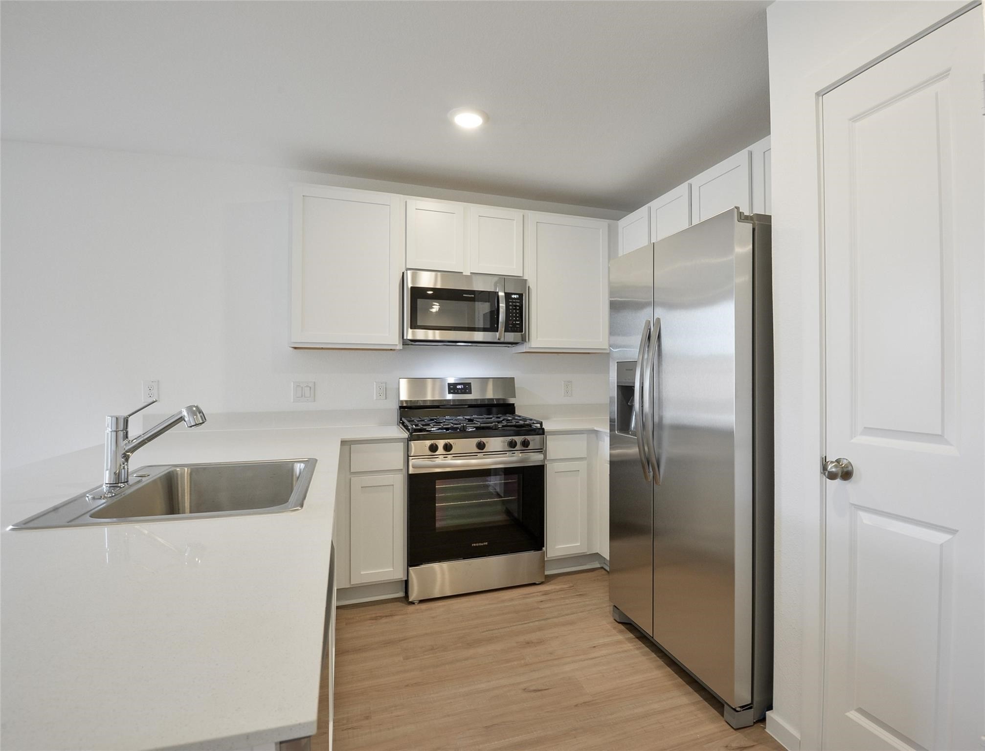 13746 Kit Run Splendora, TX 77372 - Photo 6 of 22 a kitchen with a refrigerator sink and microwave