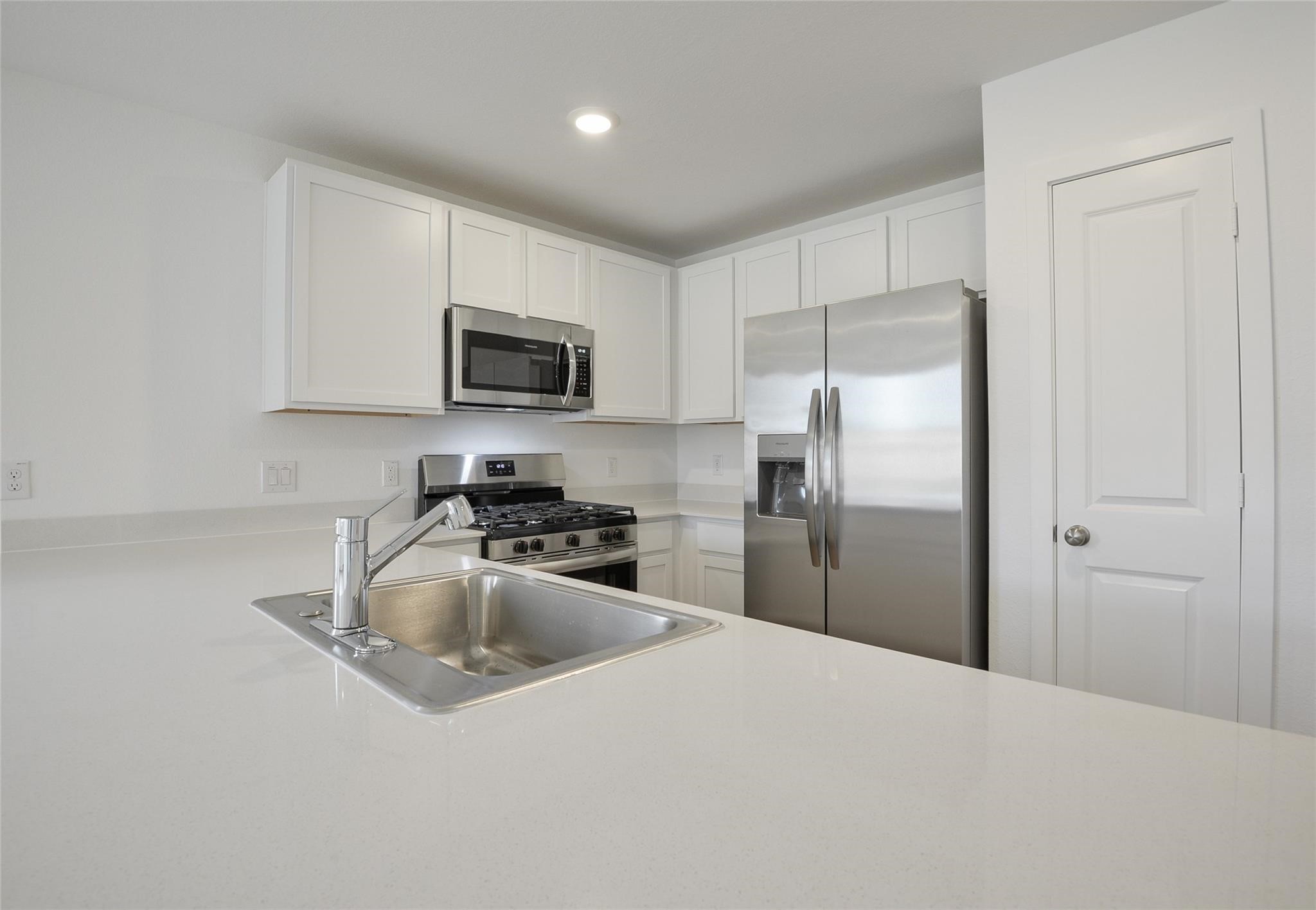 13746 Kit Run Splendora, TX 77372 - Photo 8 of 22 a kitchen with granite countertop a refrigerator and a sink