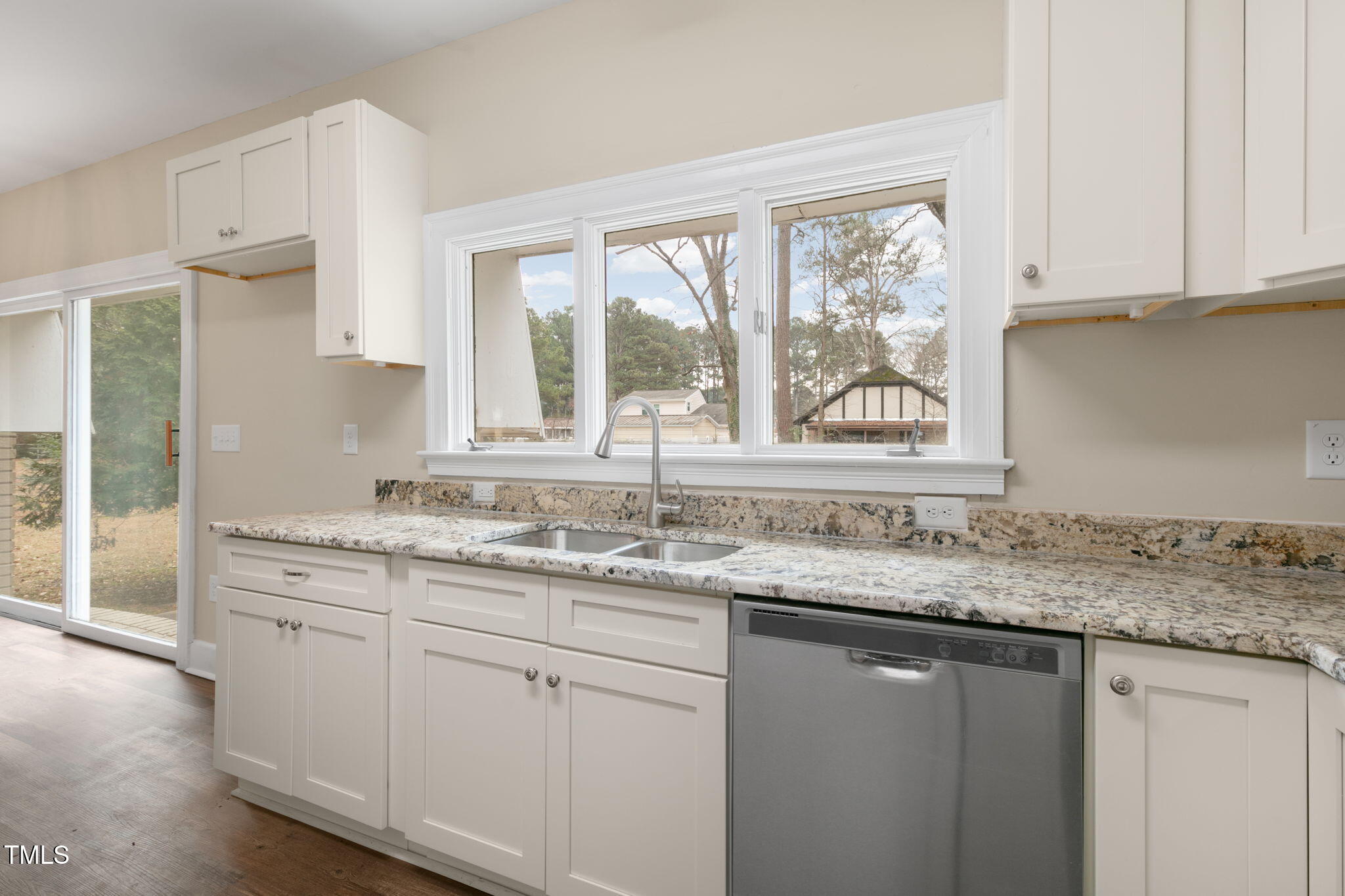 1109 Peachtree Road Northwest Wilson, NC 27896 - Photo 11 of 41 a kitchen with granite countertop white cabinets and a window