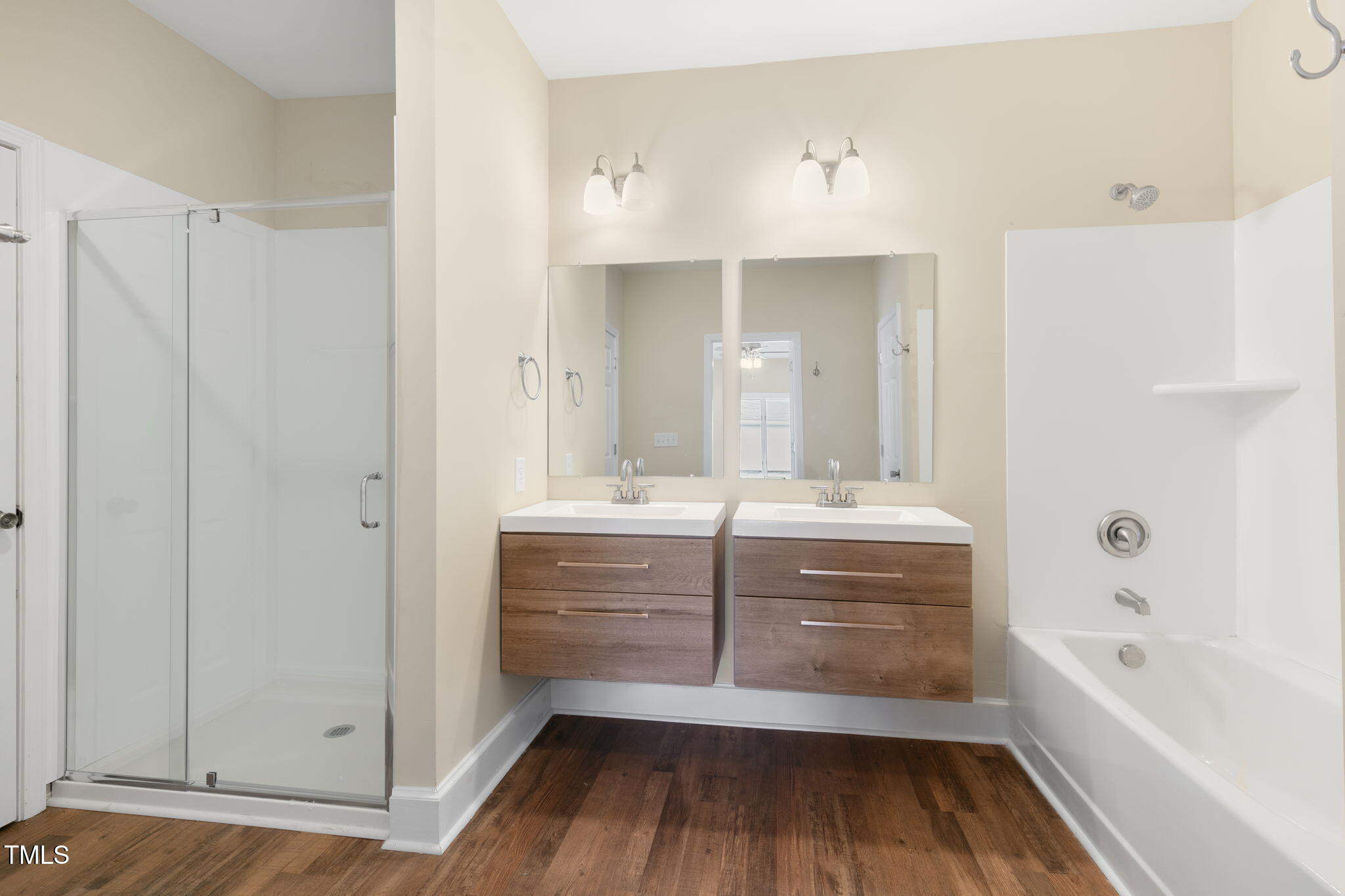1109 Peachtree Road Northwest Wilson, NC 27896 - Photo 24 of 41 a bathroom with a vanity a mirror a bathtub and a shower