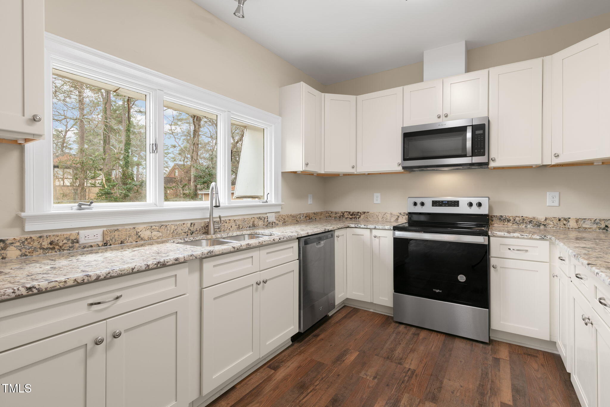 1109 Peachtree Road Northwest Wilson, NC 27896 - Photo 10 of 41 a kitchen with granite countertop white cabinets and appliances