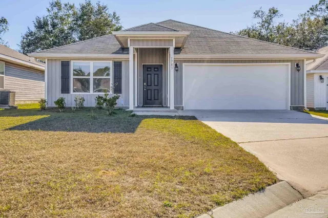 a view of yellow house with swimming pool in front of it