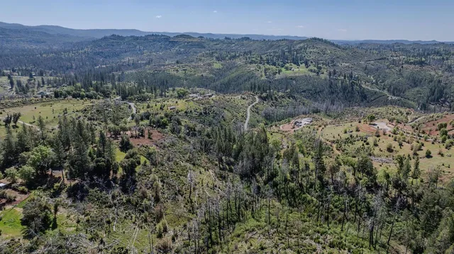 an aerial view of residential house and green space