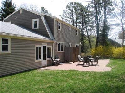 131 Stoney Cliff Road Centerville, MA 02632 - Photo 3 of 20 a view of a patio with table and chairs with wooden fence and plants