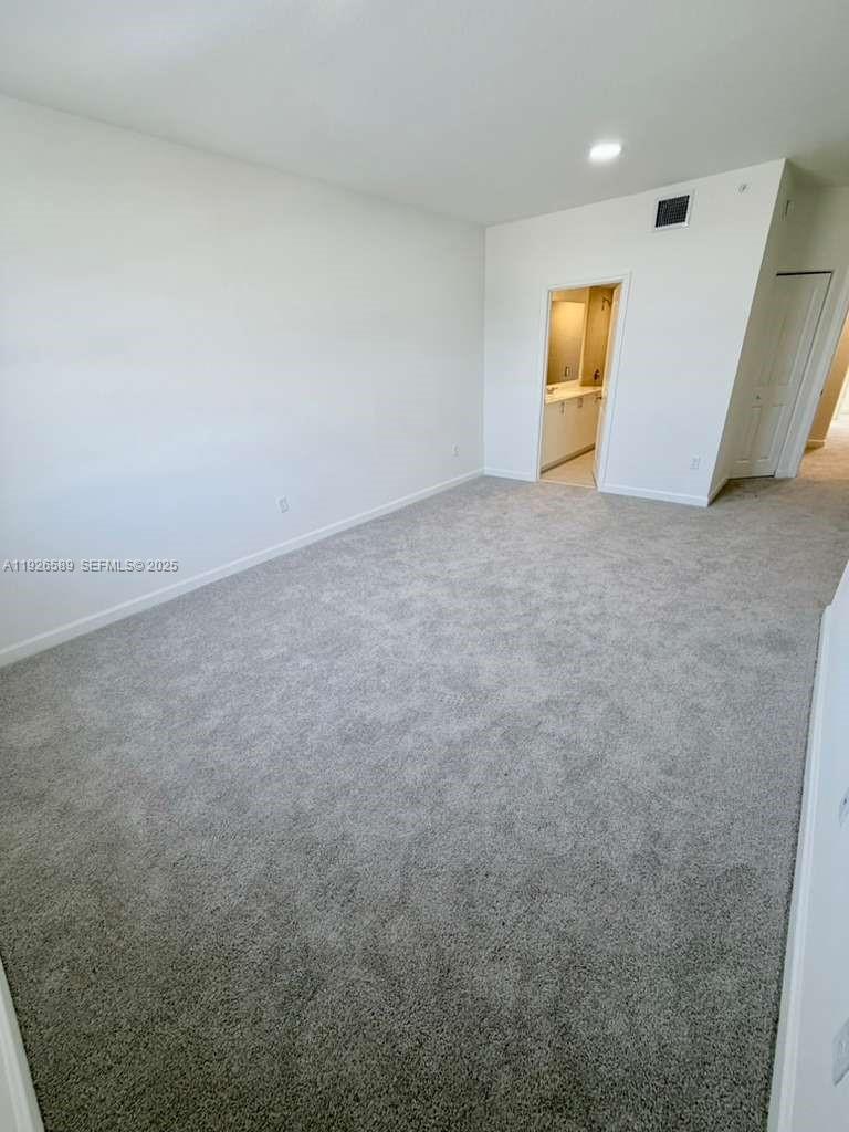 15549 Southwest 280th Street, Unit 6 Homestead, FL 33032 - Photo 11 of 13 a view of an empty room and wooden floor