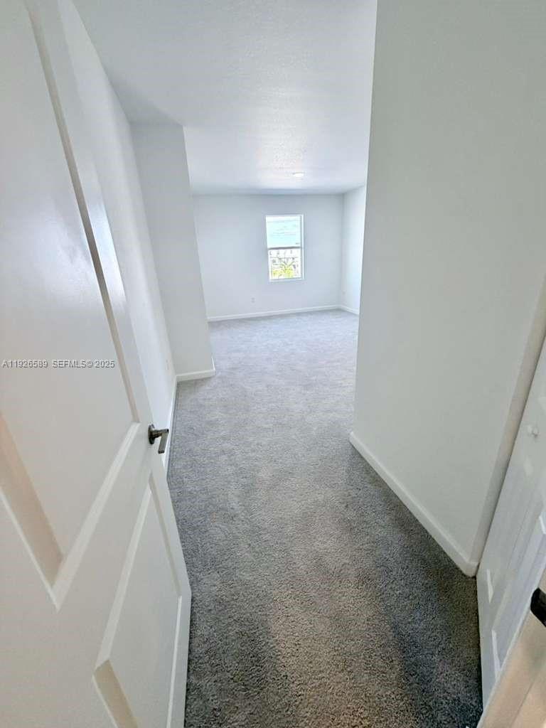 15549 Southwest 280th Street, Unit 6 Homestead, FL 33032 - Photo 12 of 13 a view of hallway with window and stairs