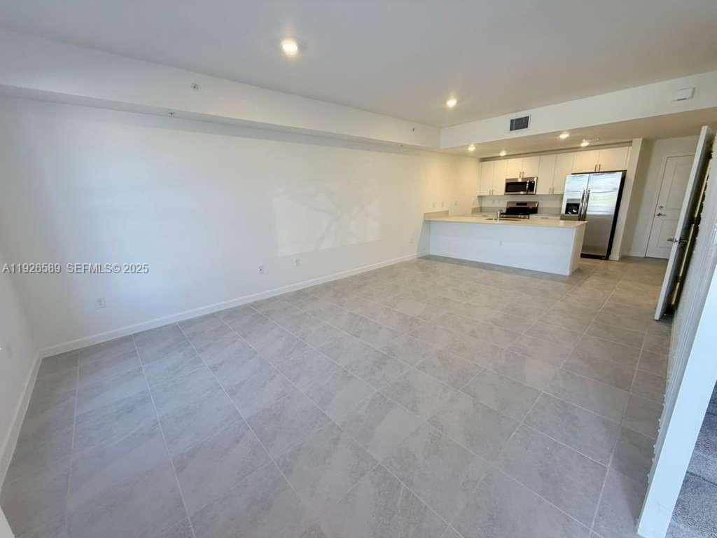 15549 Southwest 280th Street, Unit 6 Homestead, FL 33032 - Photo 2 of 13 a view of a big room with wooden floor and windows