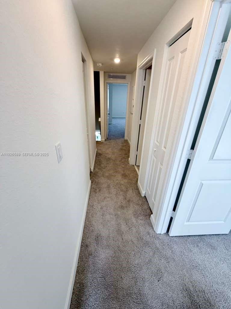 15549 Southwest 280th Street, Unit 6 Homestead, FL 33032 - Photo 7 of 13 a view of a hallway with wooden floor and staircase