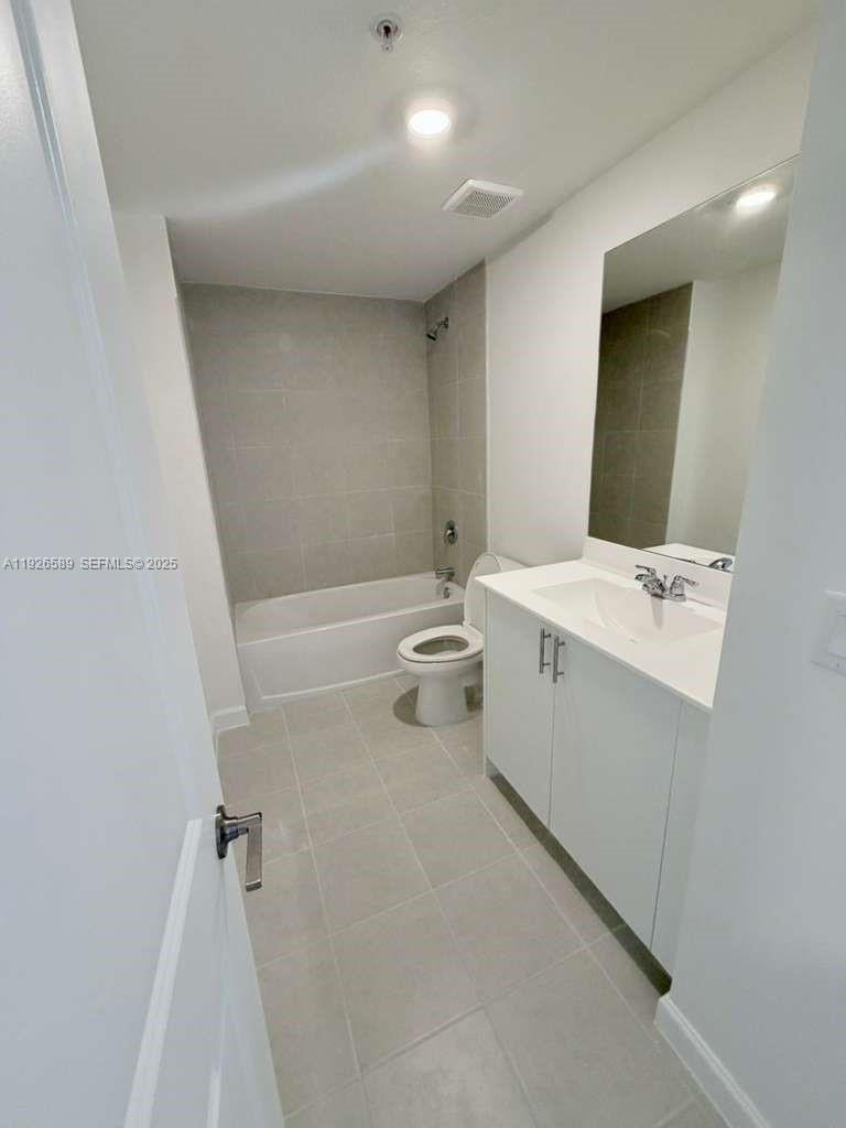 15549 Southwest 280th Street, Unit 6 Homestead, FL 33032 - Photo 8 of 13 a bathroom with a sink a toilet and shower