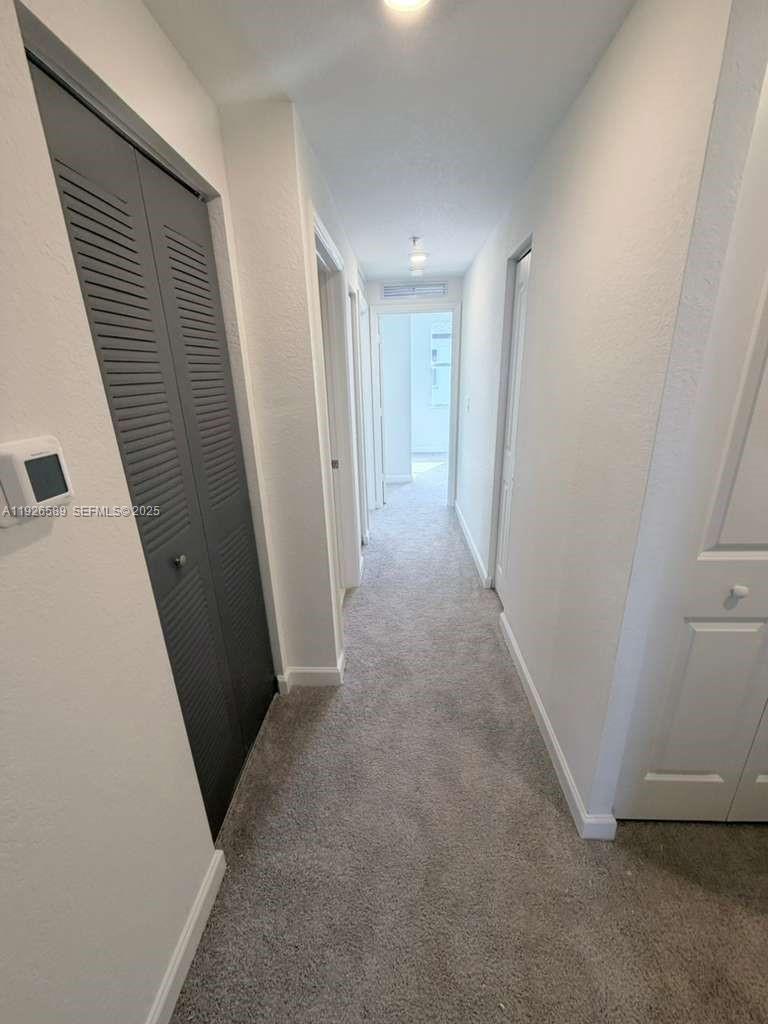 15549 Southwest 280th Street, Unit 6 Homestead, FL 33032 - Photo 9 of 13 a view of hallway with closet