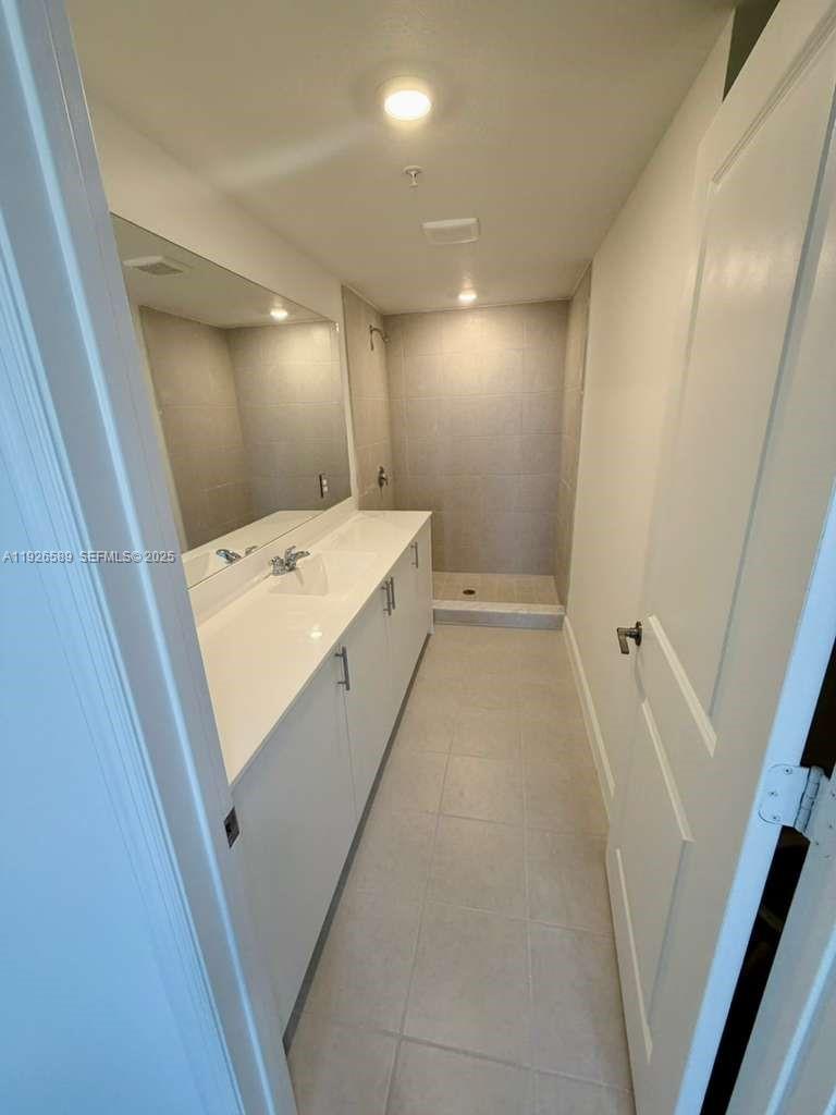 15549 Southwest 280th Street, Unit 6 Homestead, FL 33032 - Photo 10 of 13 a utility room with a washer dryer and white cabinets