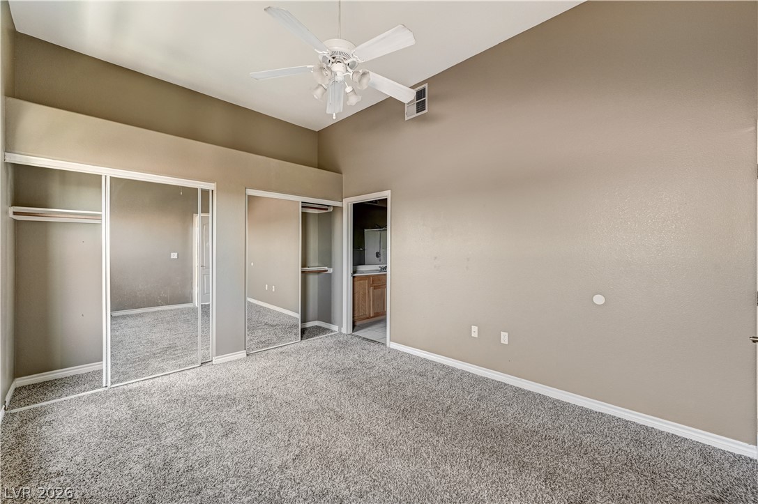 8985 South Durango Drive, Unit 2187 Las Vegas, NV 89113 - Photo 17 of 73 A comfortable bedroom boasts high ceilings and practical mirrored closet doors.