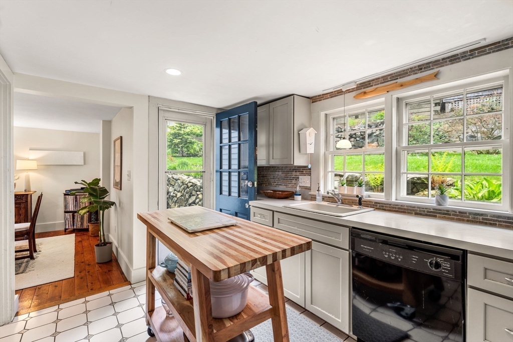 159 Elm Street, Unit 2 Marblehead, MA 01945 - Photo 11 of 34 a kitchen with a stove a sink a counter top space and living room view