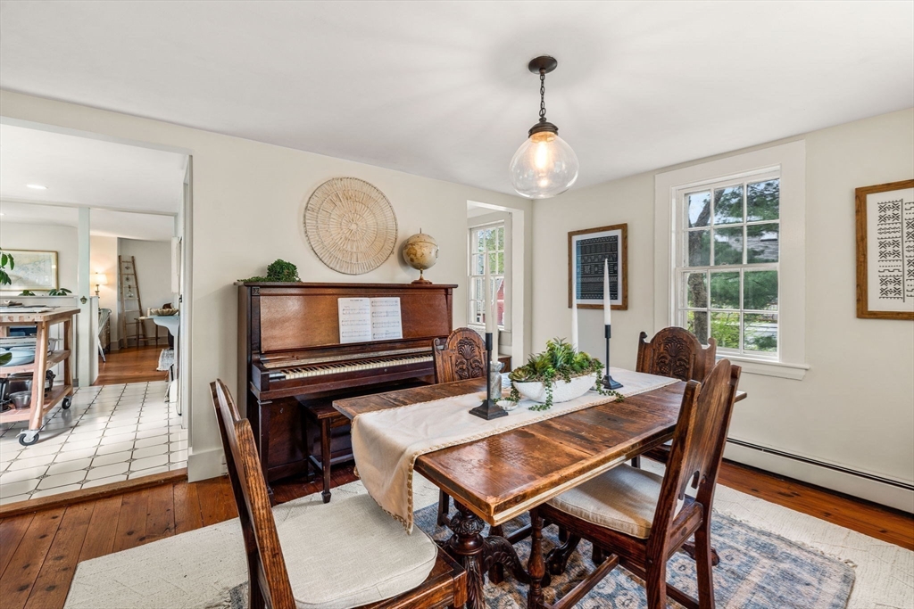159 Elm Street, Unit 2 Marblehead, MA 01945 - Photo 16 of 34 a dining room with furniture a chandelier and wooden floor