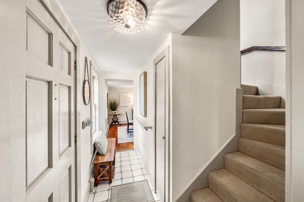 159 Elm Street, Unit 2 Marblehead, MA 01945 - Photo 18 of 34 a view of a hallway with a livingroom and a chandelier