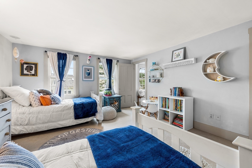 159 Elm Street, Unit 2 Marblehead, MA 01945 - Photo 19 of 34 a living room with furniture and book shelf