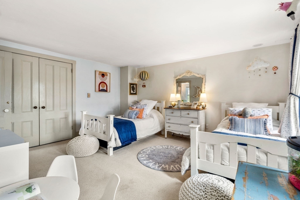 159 Elm Street, Unit 2 Marblehead, MA 01945 - Photo 20 of 34 a living room with furniture couches and a dining table with wooden floor