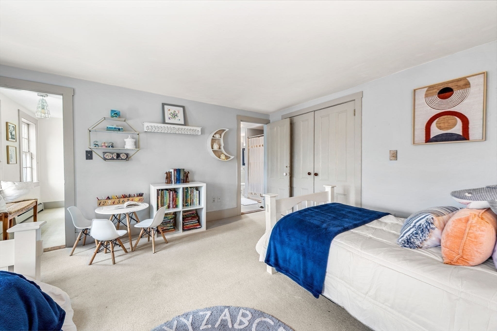159 Elm Street, Unit 2 Marblehead, MA 01945 - Photo 21 of 34 a bedroom with furniture and wooden floor