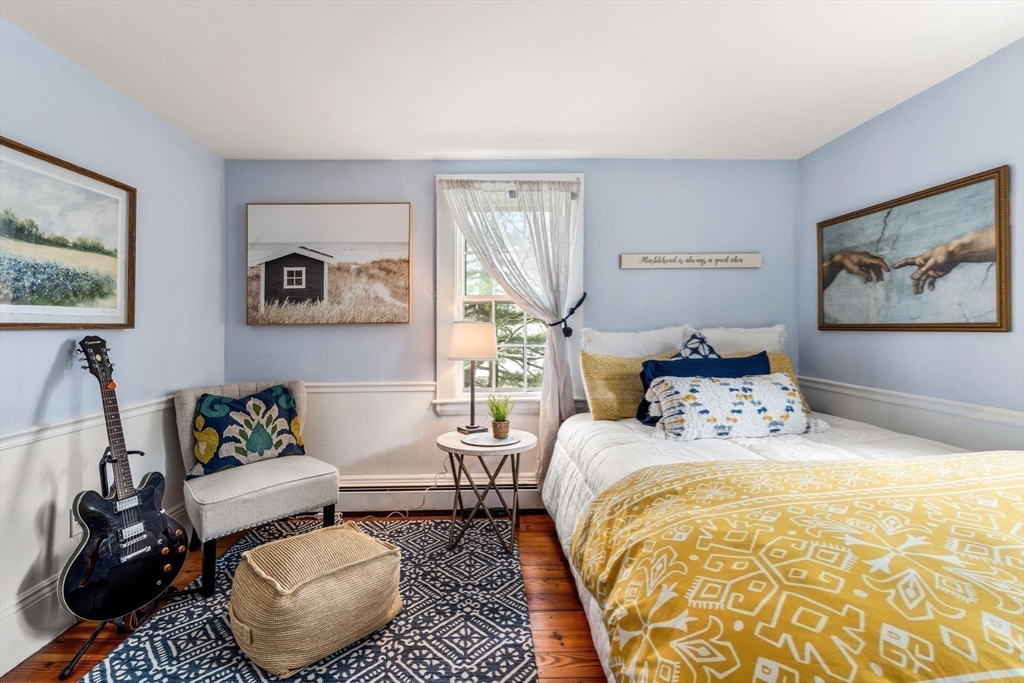 159 Elm Street, Unit 2 Marblehead, MA 01945 - Photo 24 of 34 a bedroom with a bed and wooden floor