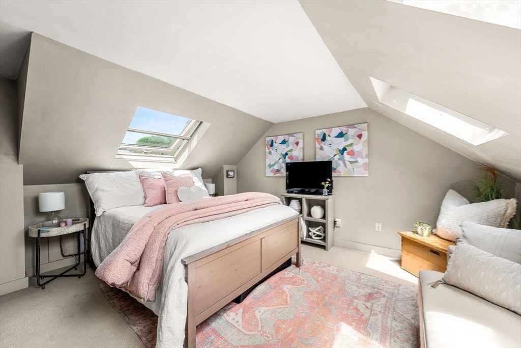 159 Elm Street, Unit 2 Marblehead, MA 01945 - Photo 28 of 34 a bed room with a bed and a couch