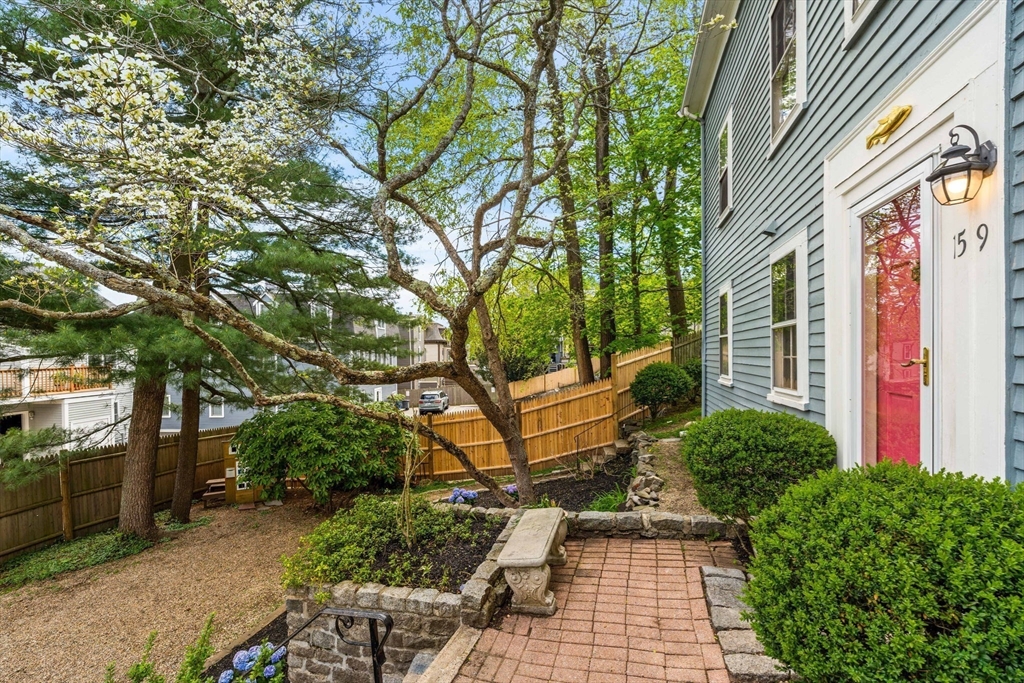 159 Elm Street, Unit 2 Marblehead, MA 01945 - Photo 3 of 34 a view of a chairs and bench in a backyard