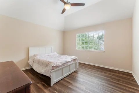a bedroom with a bed and window