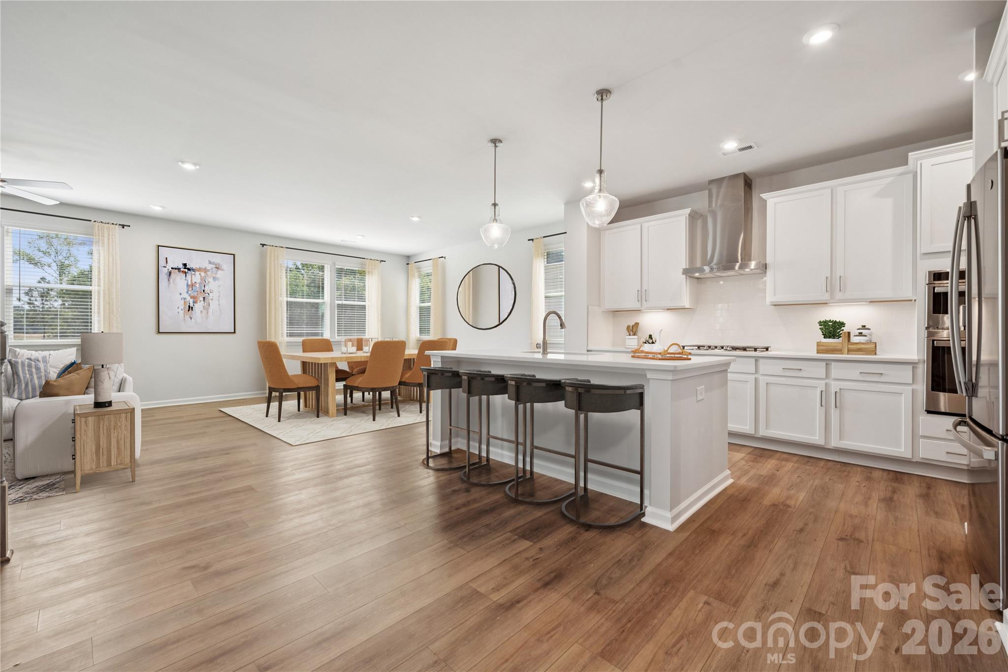 416 Alameda Way Matthews, NC 28104 - Photo 9 of 36 a open kitchen with wooden floors and white cabinets