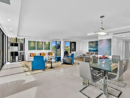 a living room with furniture and large windows