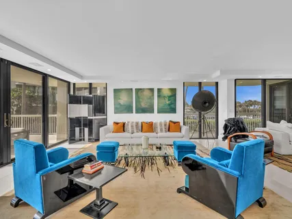 a living room with furniture large window and a table