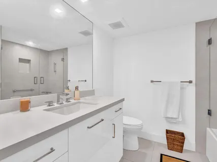 a bedroom with a bed and large windows