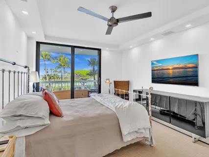 a large bedroom with a bed and large windows