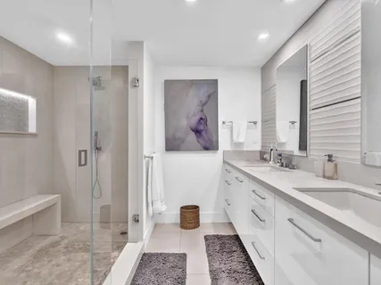 a roof deck with couches and potted plants