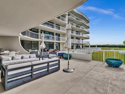 a balcony with furniture and potted plants