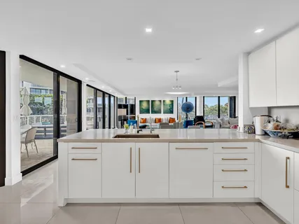 a kitchen with stainless steel appliances kitchen island granite countertop a refrigerator and cabinets