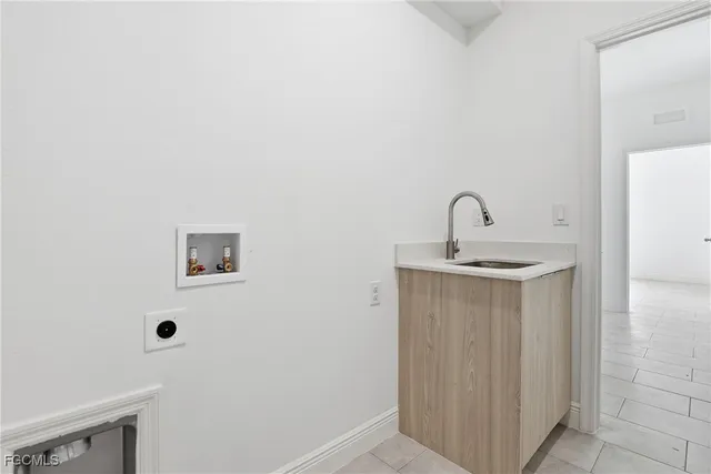 a view of a house with a yard and potted plants