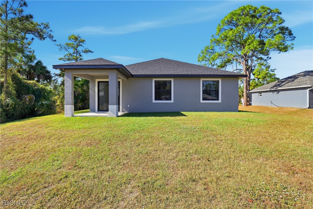1087 Rugby Circle LaBelle, FL 33935 - Photo 19 of 19 a view of a house with a yard and potted plants