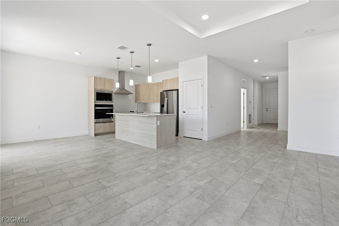 1087 Rugby Circle LaBelle, FL 33935 - Photo 3 of 19 a view of a kitchen with a refrigerator and a stove top oven