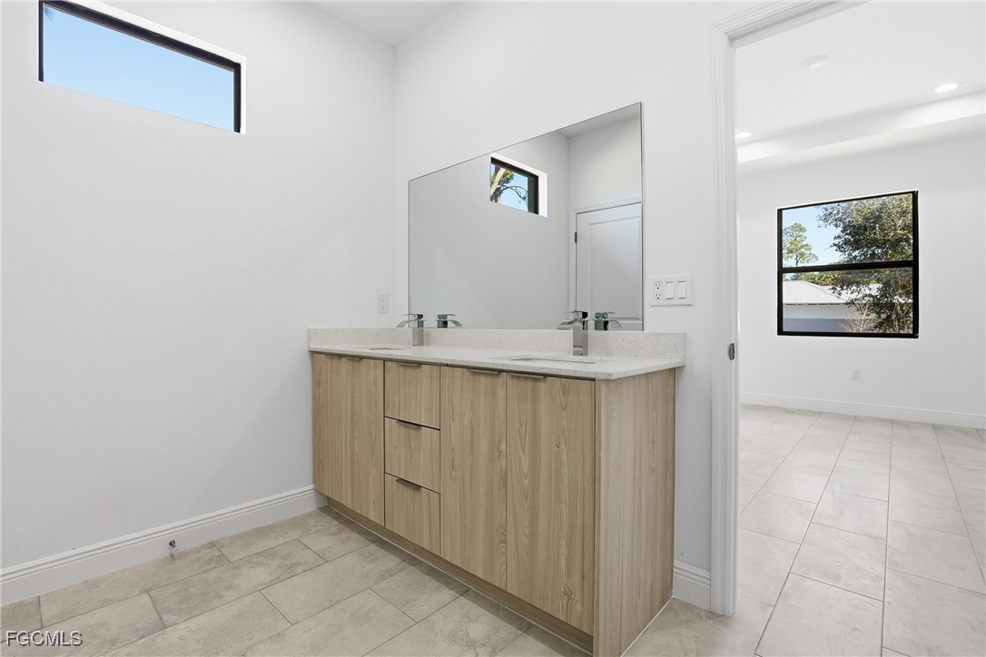 1087 Rugby Circle LaBelle, FL 33935 - Photo 10 of 19 a bathroom with a sink and a mirror