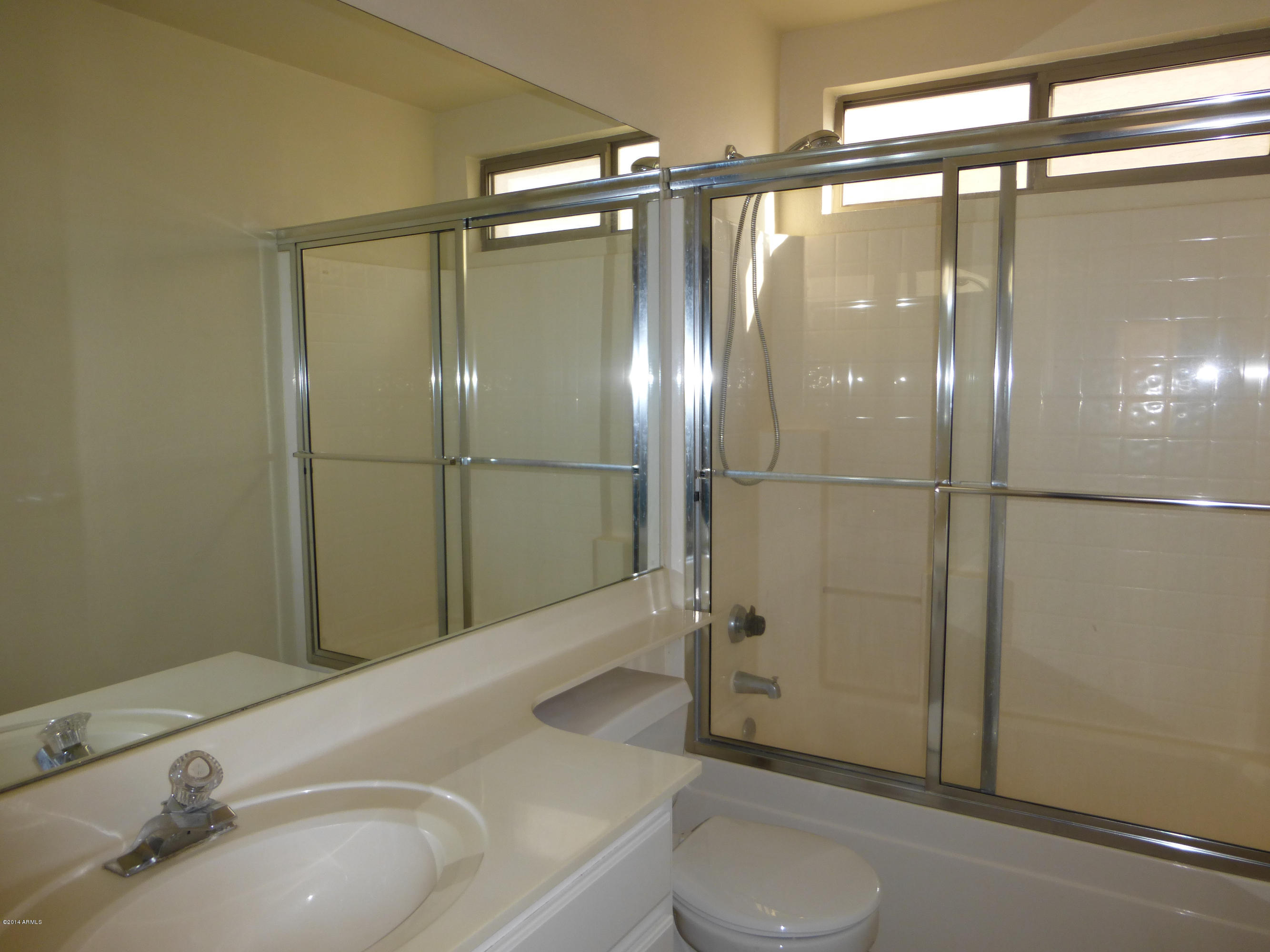 3927 East Agave Road Phoenix, AZ 85044 - Photo 15 of 21 a bathroom with a sink and a mirror