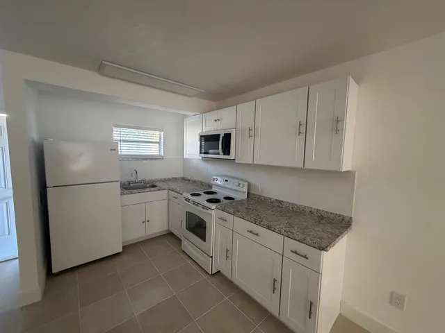 a kitchen with a sink stove and refrigerator