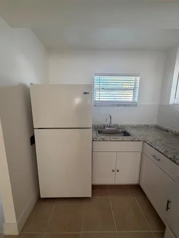 a white refrigerator freezer sitting in a kitchen