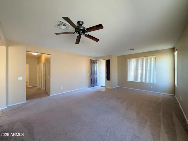 a kitchen that has a lot of cabinets in it and stainless steel appliances