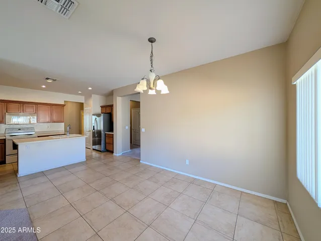 a view of an empty room with a window and fireplace