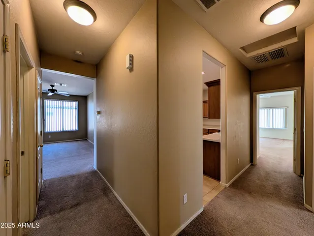 an empty room with a ceiling fan and a window