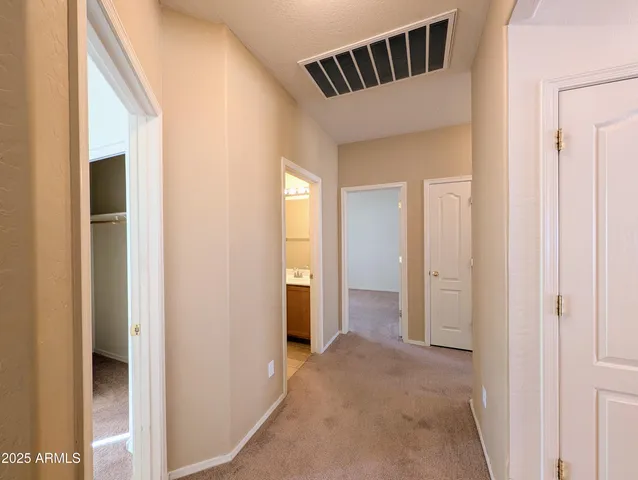 a view of an empty room with a ceiling fan
