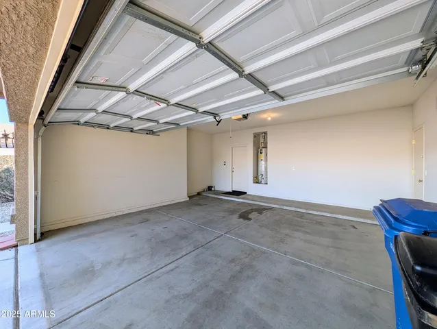 a view of empty room with windows and ceiling fan