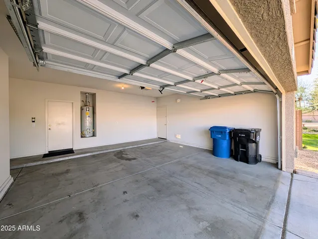 an empty room with a ceiling fan and a window