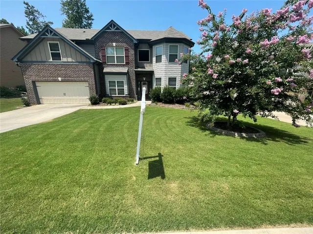 a front view of a house with a yard