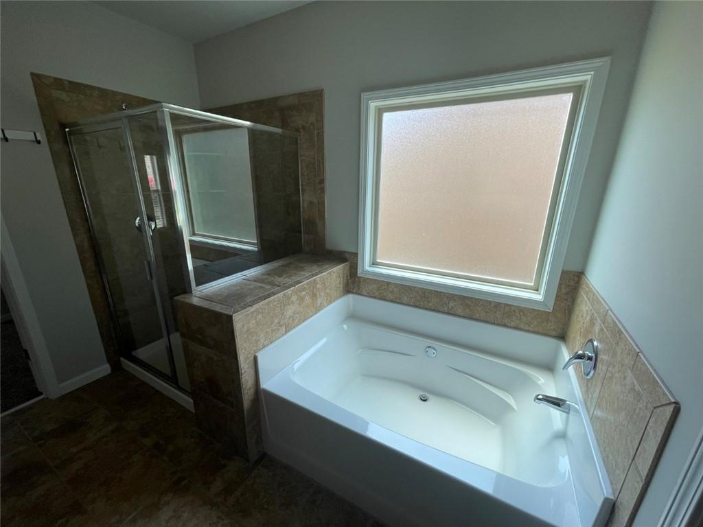 4810 Haysboro Way Cumming, GA 30040 - Photo 18 of 48 a bathroom with a bathtub and a window